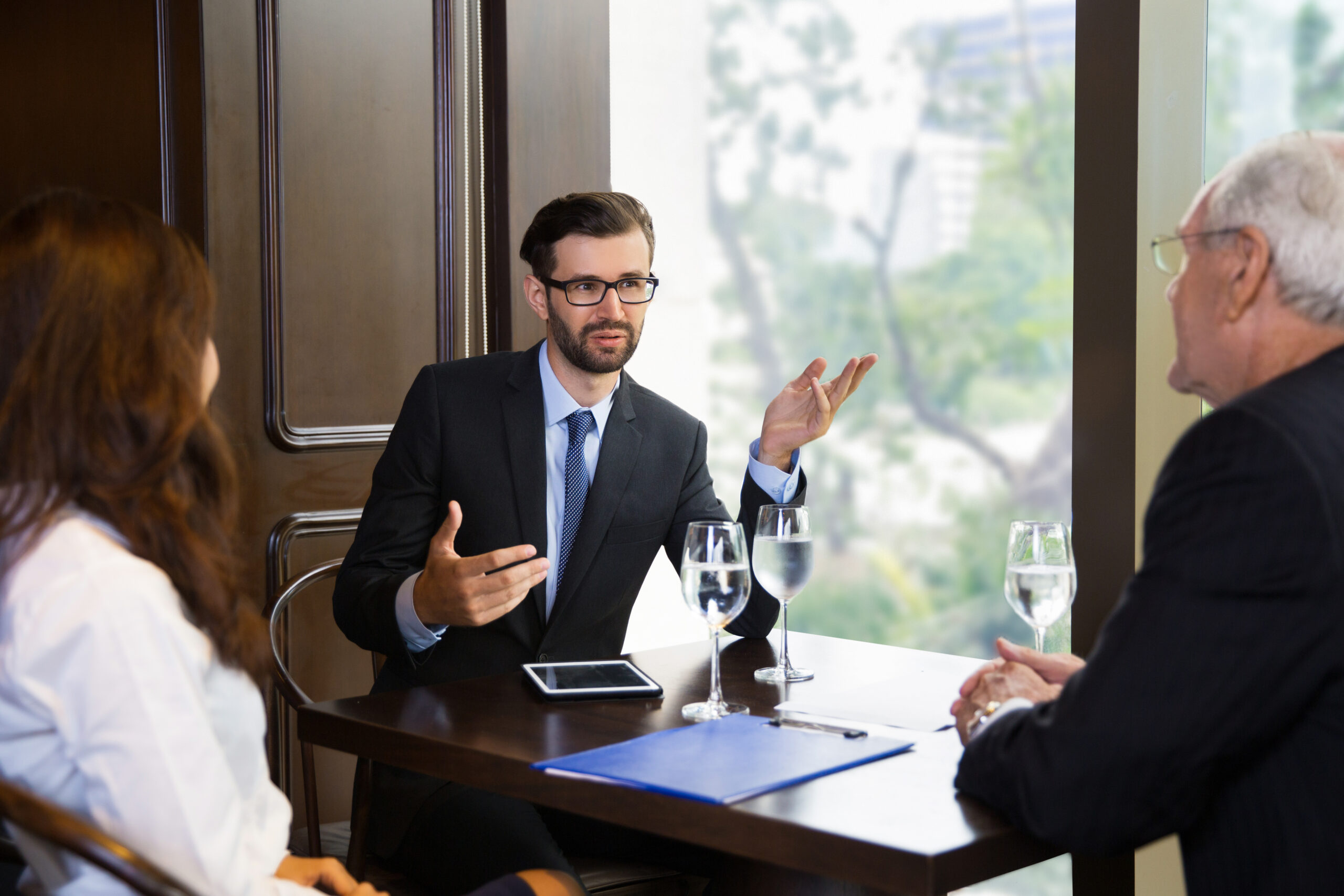 Three Business People Negotiating at Table